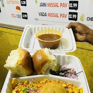 a person holding a tray of food