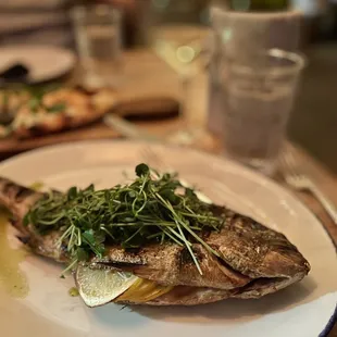 Whole fish.. market price, ours was $55, perfectly seasoned, cooked right and yes good for sharing!