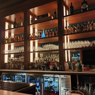 a bar with many bottles of alcohol