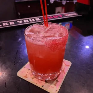 a drink in a glass on a coaster