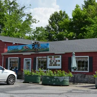 a car parked in front of a red building