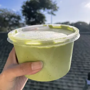 a hand holding a cup of it