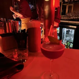 a bartender pouring a drink at a bar