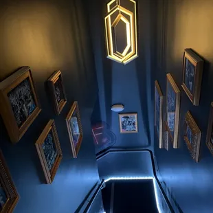 an escalator with pictures on the wall