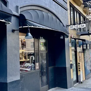 On Mason St, next door to the right of Bodega. Look for the illuminated cartoon cat.