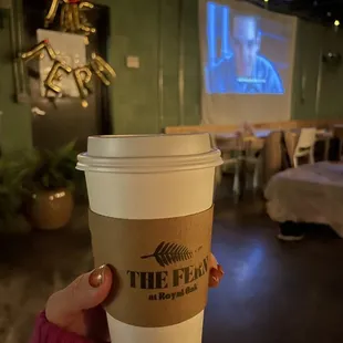 a person holding a cup of coffee