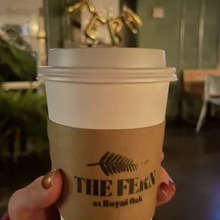 a person holding a cup of coffee