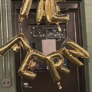 a bunch of gold balloons in the shape of guns