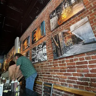 a brick wall with pictures on it