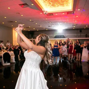 bride bouquet toss at wedding reception