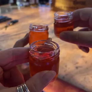 a group of people holding glasses of liquid