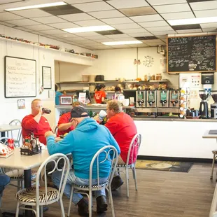 people sitting at tables in a restaurant