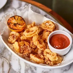 a plate of fried food with dipping sauce