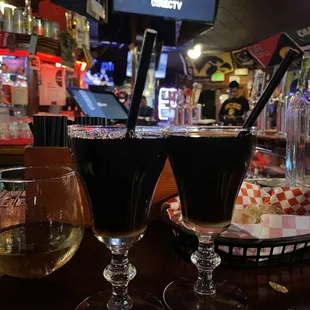 two glasses of beer on a bar