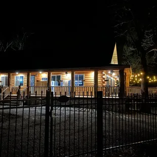 a log cabin lit up at night