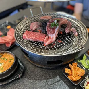 a variety of meats being cooked