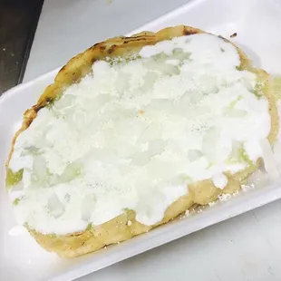 Picaditas salsa verde o roja / Hand made Tortilla with green or red sauce cream, cheese and onion.
