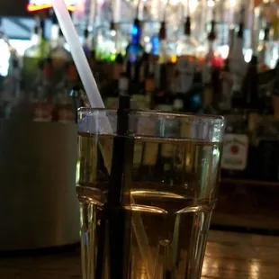 a glass of water with a straw in it