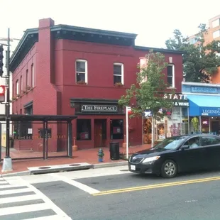a black car driving down the street