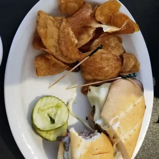 Roast beef sandwich, pickles and homemade potato chips