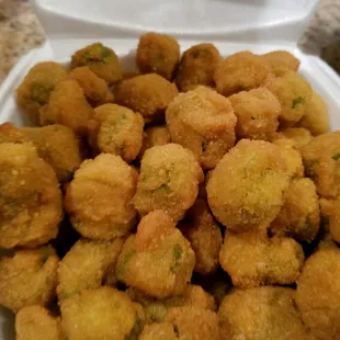 a white container filled with fried fish