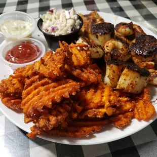 Yummy blackened scallops, shrimps, grouper, and sweet potato fries.
