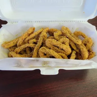  onion rings in a styrofoam container