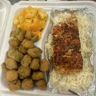 Grilled salmon on a bed of rice with fried okra and mac&apos;n cheese