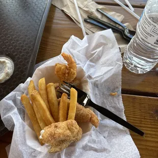 a basket of fried fish and fries