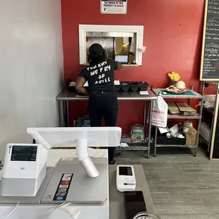 a woman standing at the cash register