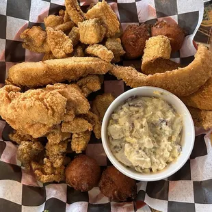 Alligator, Catfish, Flounder, Chicken strips, Hushpuppies, and Potato Salad