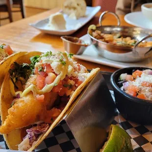 a plate of fish tacos and a bowl of rice