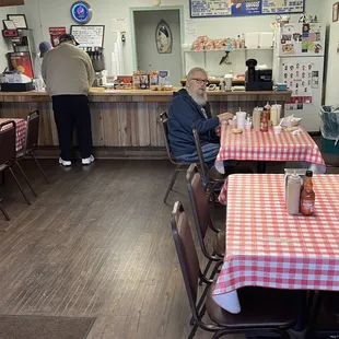 a man sitting at a table in a restaurant