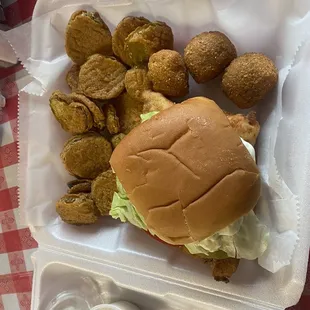 Fish sandwich, hush puppies and fries pickles