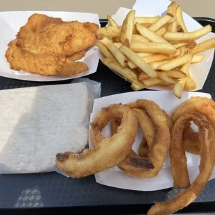 Two Piece Fish Sandwich on Rye Bread with Fries and Onion Rings