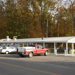 a red truck parked in front of a white building