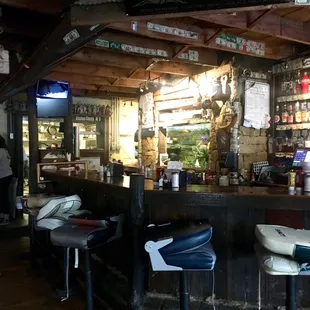 Fishing theme is carried out well inside the. At. Fishing boat seats as bar stools is a nice touch.