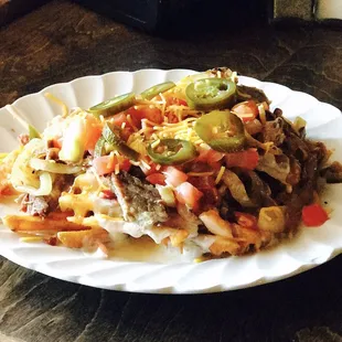 Waf-Chos. Wed. Night Special. Waffle Fries topped with queso cheese, beef brisket, tomatoes, jalapeño. Mmmmmm! Good!!!