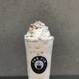 Iced chai with whip and cinnamon sprinkles