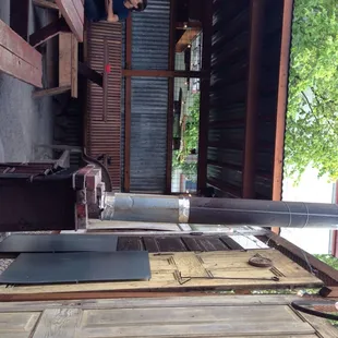 One of two outdoor patios! Lil hot but personal feel with the old door borders and wood stove.