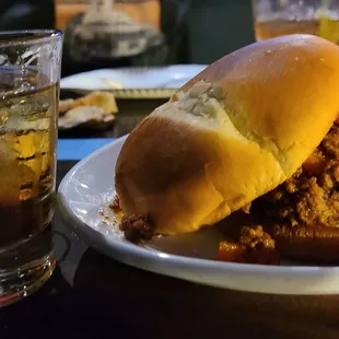 Sloppy Joe (partially eaten), Jameson on the rocks,  and a kool-aid pickle of in the distance.