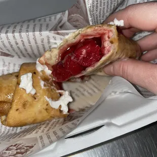 a hand holding a sandwich