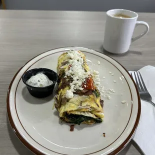 a plate of food and a cup of coffee