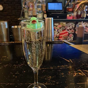 a glass of champagne on a bar