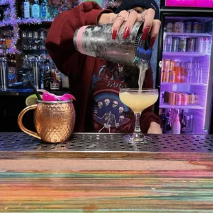 a bartender pouring a cocktail