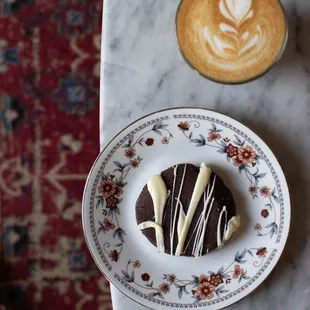 a cup of coffee and a plate of cookies