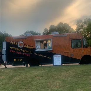 an orange and black food truck