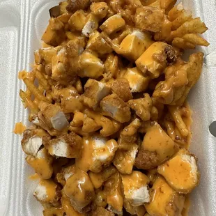 a container of chicken and cheese fries