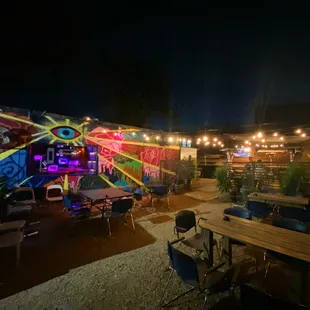 a brightly lit patio with tables and chairs