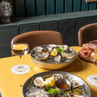 Oysters, Combo Board, and Champagne in our closed outdoor area, The Green Room.
